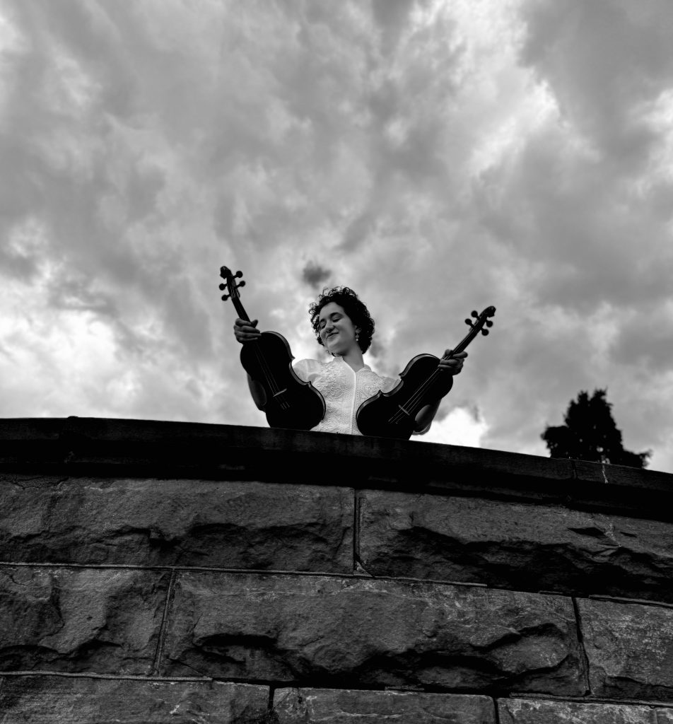 Woman holding two violins